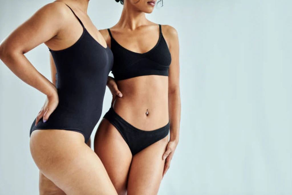 two women's torsos pictured in black bathing suits