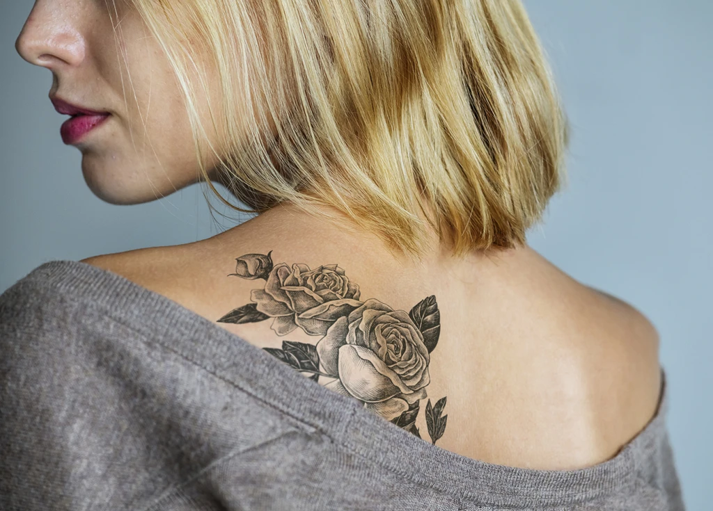 Female with a rose tattoo on shoulder blade