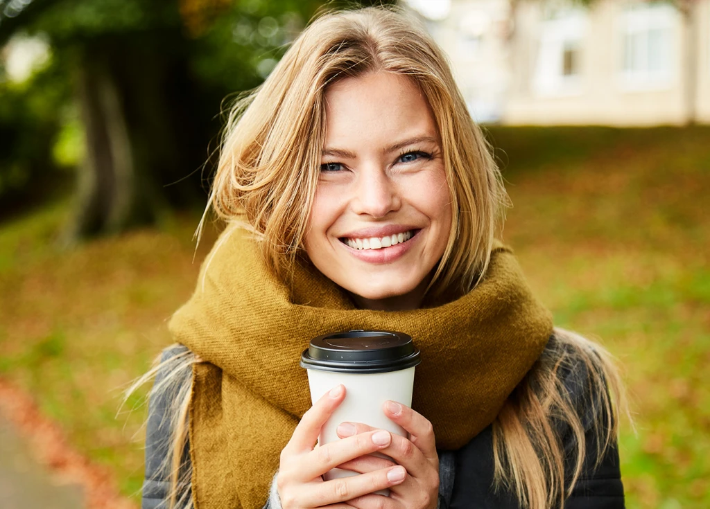 Woman with scarf and coffee cup